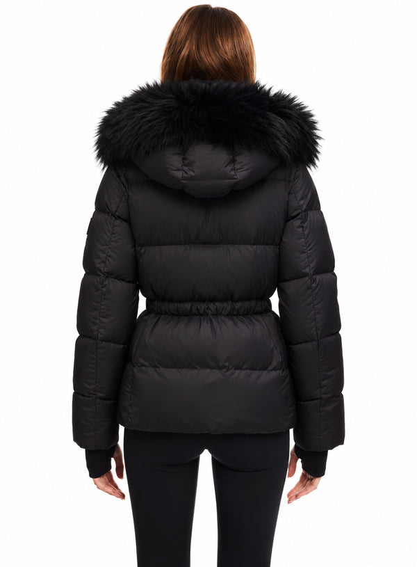 DELANEY A woman viewed from the back wearing a black puffer jacket with a large black faux-fur hood trim and a matching black belt, paired with black leggings, against a plain white background.