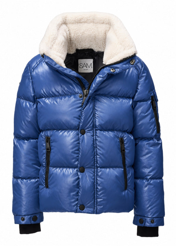 BOYS FRONTIER A royal blue puffer jacket with a thick cream-colored sherpa lining on the hood, black zipper details, and black cuffs, shown against a plain white background.